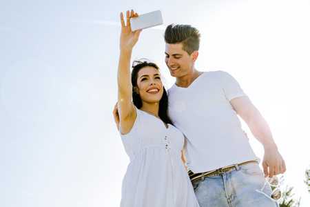 Beautiful  young couple taking a self portrait on a summer dayの写真素材