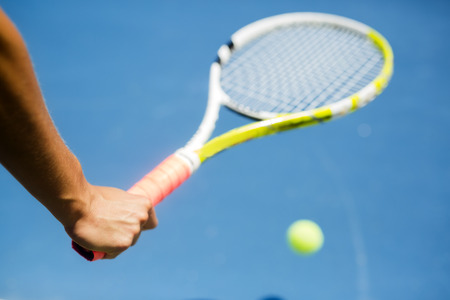 Closeup of a player holding the racquet and preparing for the serve at the baselineの写真素材
