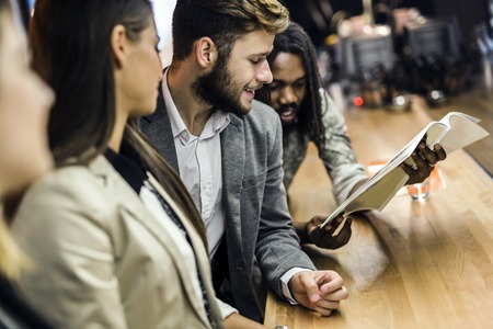 People discussing article in a pub after workの写真素材