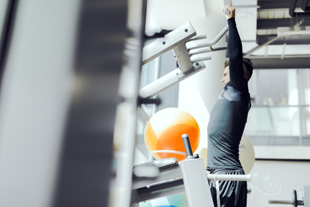 Young handsome man working out in a  gym and living a healthy lifestyle