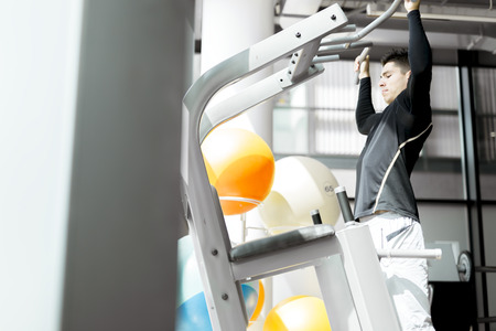 Young handsome man working out in a  gym and living a healthy lifestyleの写真素材