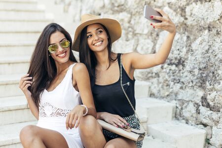 Friends taking selfie of themselves during summertimeの写真素材