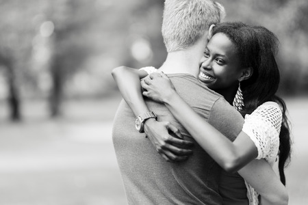 Couple in love hugging peacfully outdoors and being truly happy. Feeling of security and serenityの写真素材