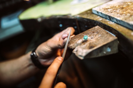 Jeweler working on ring in his workshopの写真素材