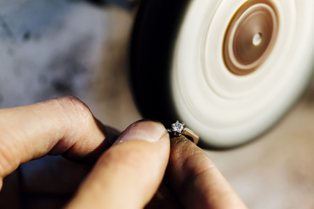 Jewelery polishing ring in workshop with adequate toolsの写真素材