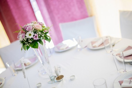 Wedding decoration with flowers in vase on a table