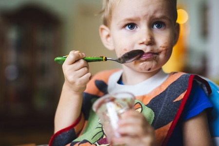 Smeared child eatingの写真素材