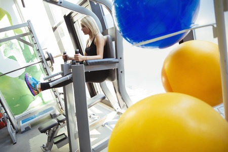 Beautiful woman training in gym and keeping body in shape