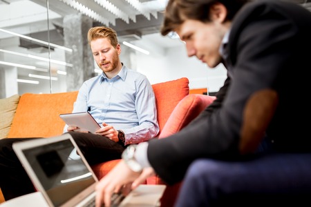 Business colleagues resting and talking during breakの写真素材