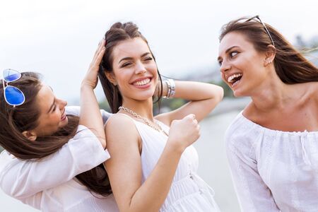 Cheerful women having fun outdoors and laughing happilyの写真素材
