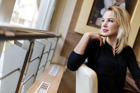 Blonde businesswoman looking out the window