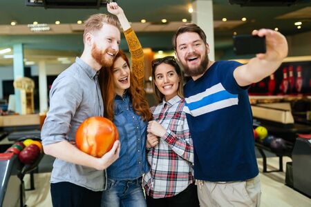 Friends taking selfies of themselves bowlingの写真素材