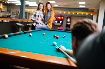 Snooker player aiming at billiard table