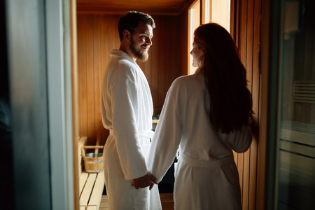 Couple enjoying finnish sauna during their spa weekendの写真素材