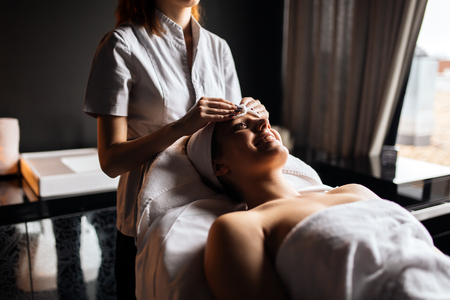 Beautiful woman enjoying massage and rejuvenatingの写真素材