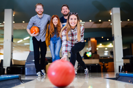 Friends enjoying recreational  bowling at clubの写真素材