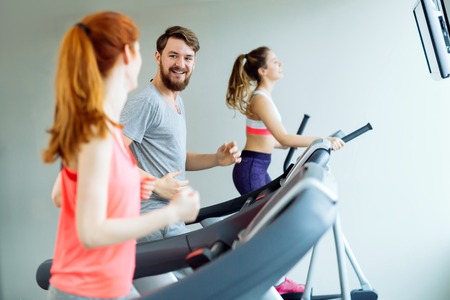 People traning in gym on various machines as part of cardio workout