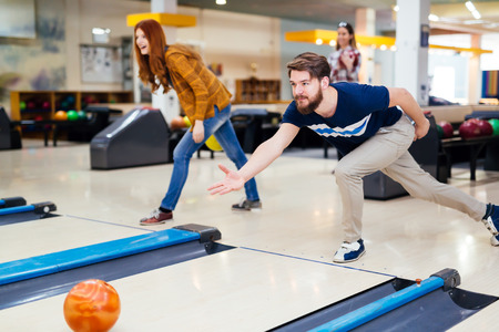 Friends enjoying recreational bowling club atの写真素材