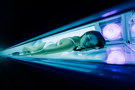 Beautiful sexy woman tanning in solariumの写真素材