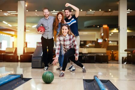 Friends having fun while bowling and speding time togetherの写真素材