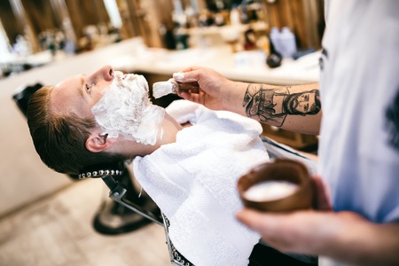 Retro shaving with foam in barber shopの写真素材