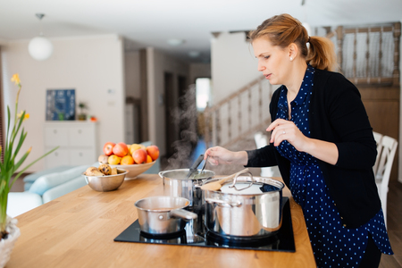 Woman making organic  lunch in modern kitchenの写真素材