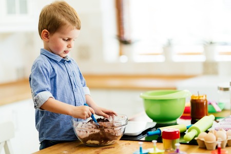 Adorable child below the age of 3  making cookies in kitchenの写真素材