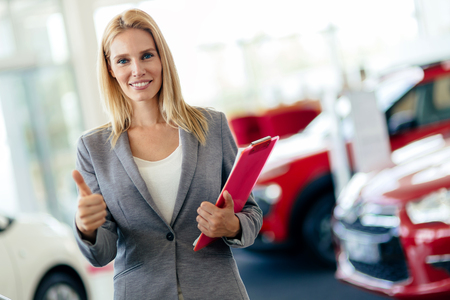 Professional salesperson working in car dealershipの写真素材