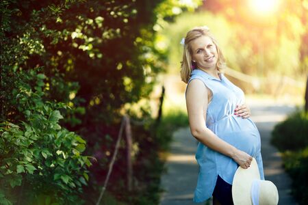 Portrait of a beautiful pregnant woman in nature