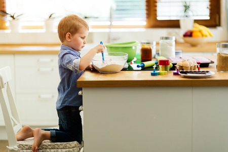 Adorable child below the age of 3  making cookies in kitchenの写真素材