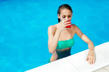 Beautiful woman enjoying summer vacation in pool