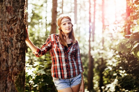 Beautiful blond woman posing in forestの写真素材