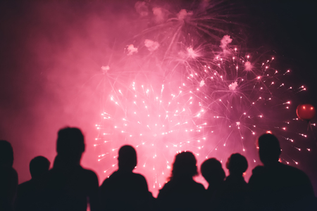 Crowd wathcing fireworks and celebratingの写真素材