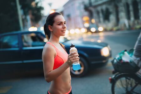 Woman jogging at night in cityの写真素材