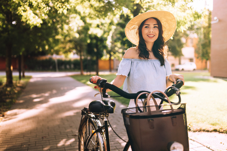 Beautiful woman using bicycle as means of transportの写真素材