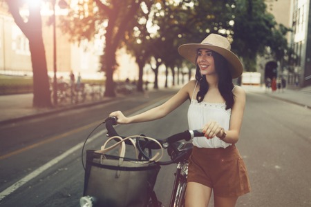 Tourist woman using bicycle as means of transportationの写真素材