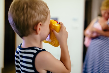 Cute boy wants to become photographerの写真素材