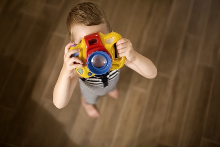 Cute boy wants to become photographerの写真素材