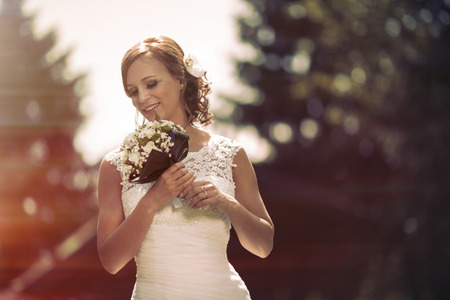 Beautiful bride with flower in hair  outdoorsの写真素材