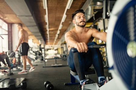 Ripped bodybuilder working out in gymの写真素材
