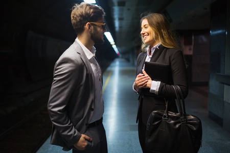 Business colleagues talking at subway  stationの写真素材