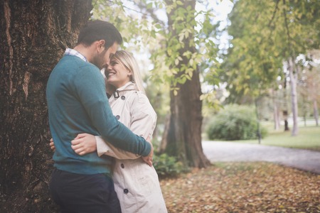 Loving happy couple hugging in park