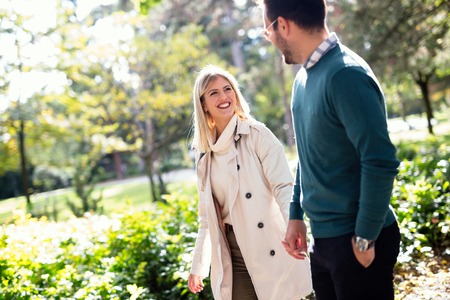 Loving happy couple walking in parkの写真素材