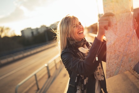Tourist woman holding travelers map  to travel to destinationの写真素材