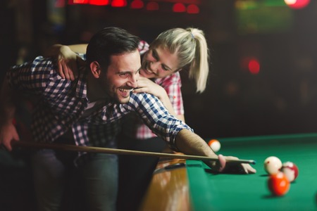 Couple dating and having fun playing snookerの写真素材