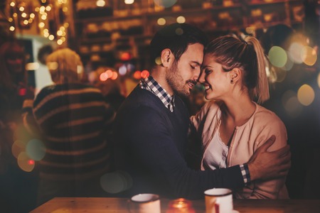 Romantic couple dating at night in pubの写真素材