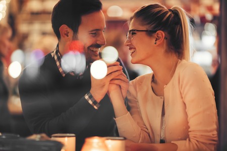 Romantic couple dating at night in pubの写真素材