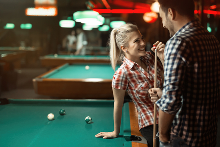 Couple playing snooker together