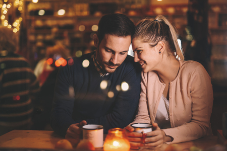 Romantic couple dating at night in pubの写真素材