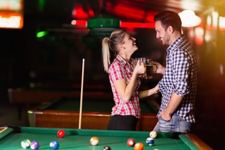 Couple dating and having fun playing snooker
